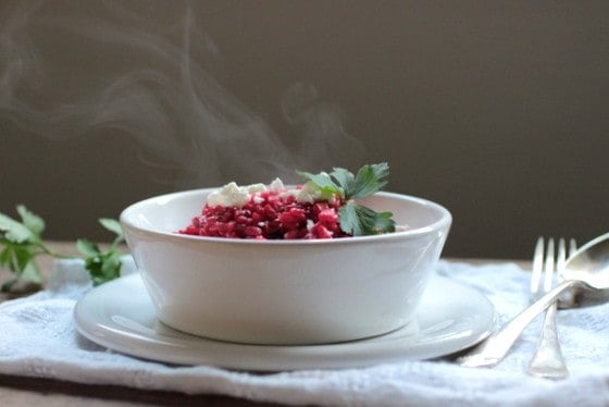 White bowl with steaming Roasted Beet Risotto on white cloth