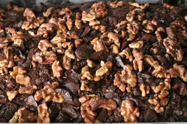 Close up of chocolate chip cake topped with walnuts
