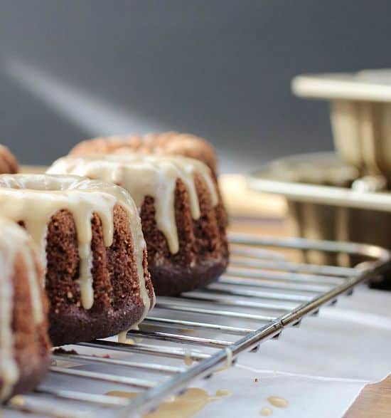 Row of Mini Bundt Cakes dripping coffee glaze on wire rack