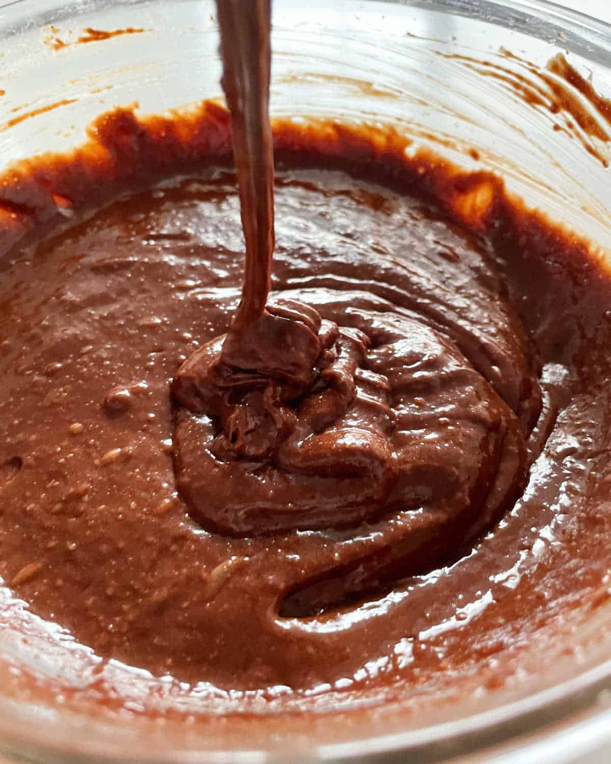 Chocolate batter in a glass bowl.
