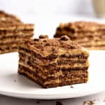 White plate and background with servings of Argentinian chocotorta.