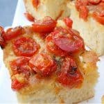 Close up of tomato bread square on white plate
