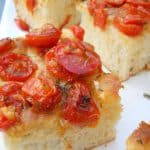 squares of roasted tomato focaccia bread on a white plate