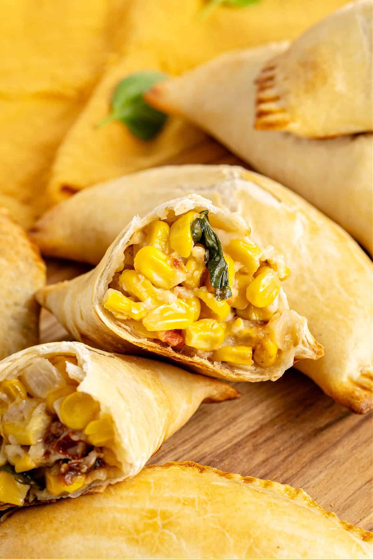 Halved corn empanada with whole ones.