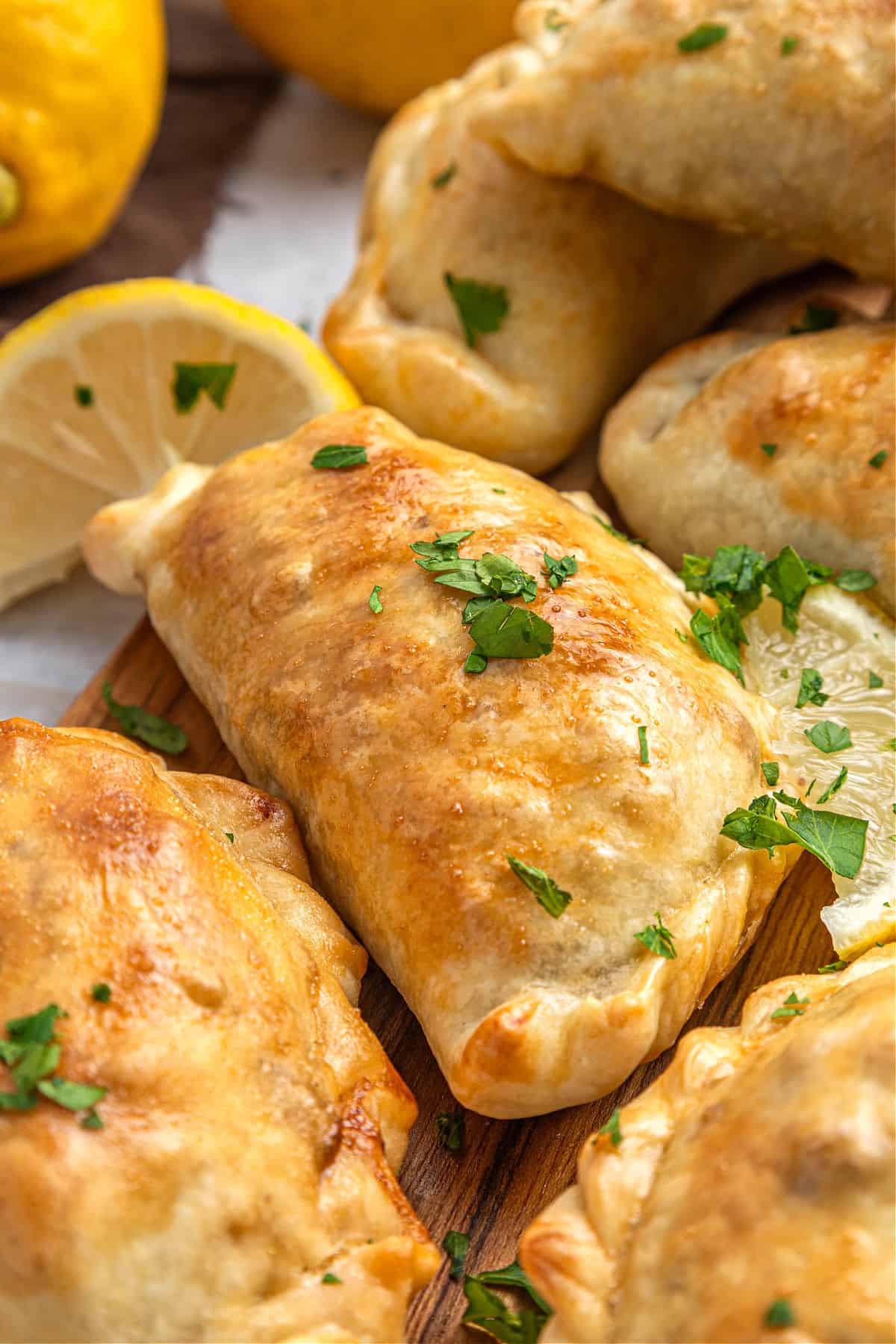 Close up meat empanadas with butter dough. Chopped parsley.