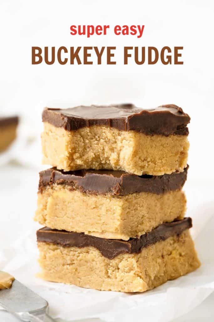 Pieces of peanut butter chocolate fudge stacked on a white surface. Brown and red text overlay.