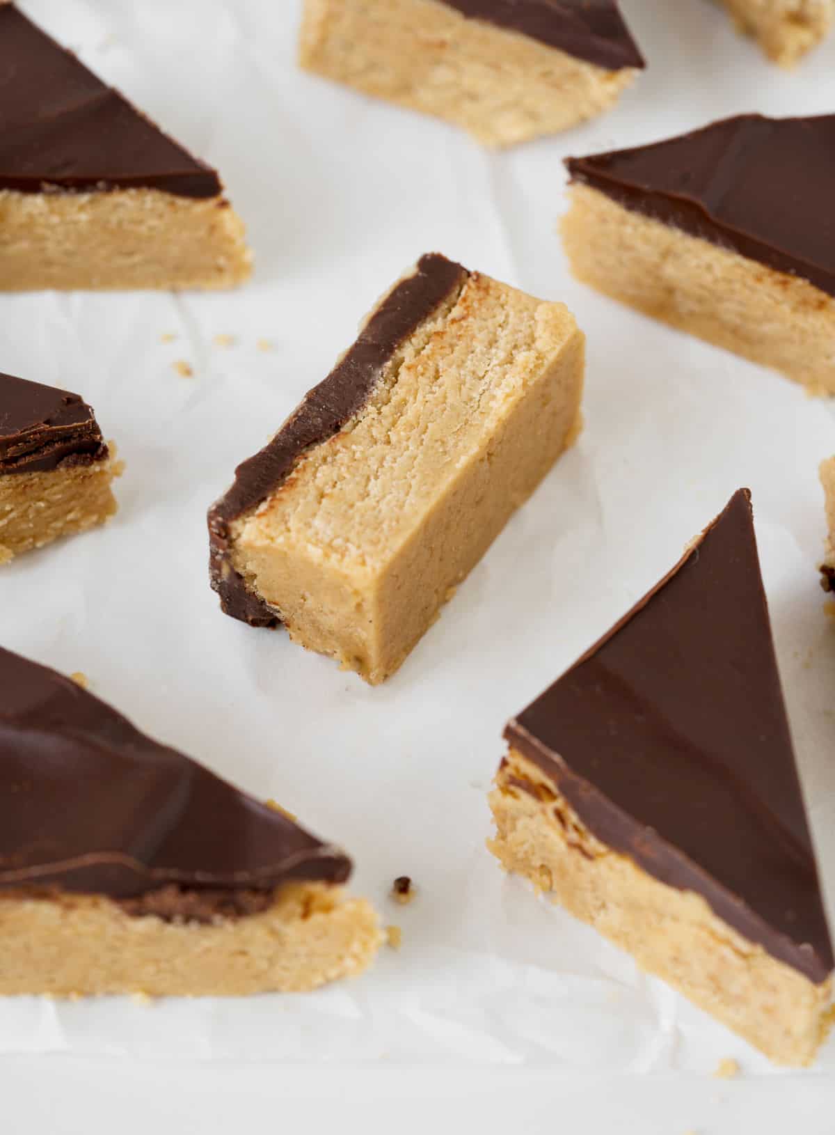 Several pieces of buckeye fudge on white parchment paper.