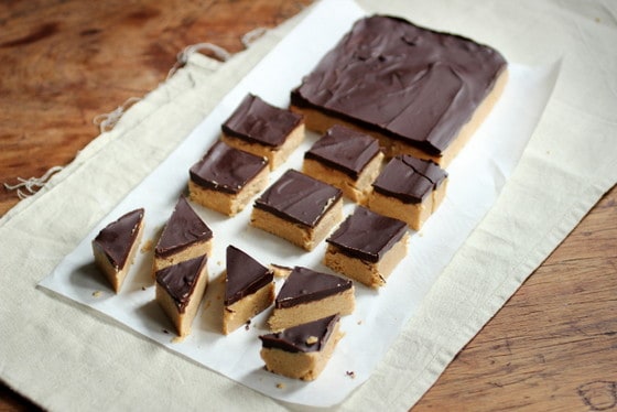 Top view of pieces of chocolate topped peanut butter fudge on a light colored cloth