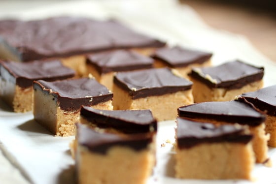 Rows of peanut butter chocolate fudge squares on a light colored surface