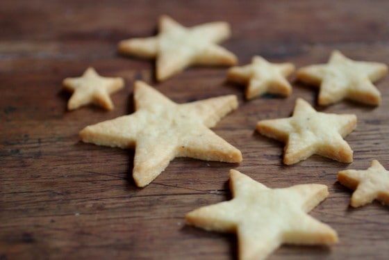 Several cheese cookies flat on a wooden surface.