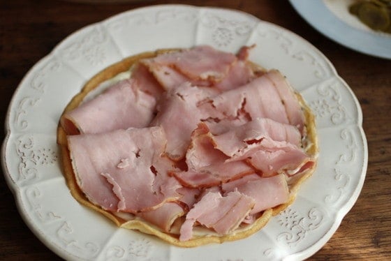 White plate with ham topping a crepe