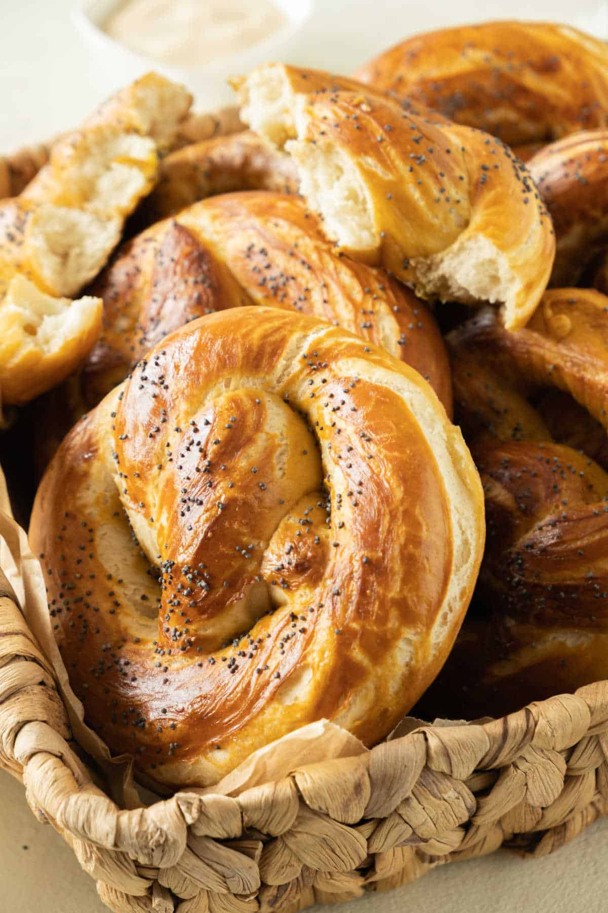 Basket with soft pretzels, whole and halved. Close up image.