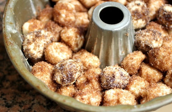 Unbaked monkey bread pieces in a bundt cake pan. 