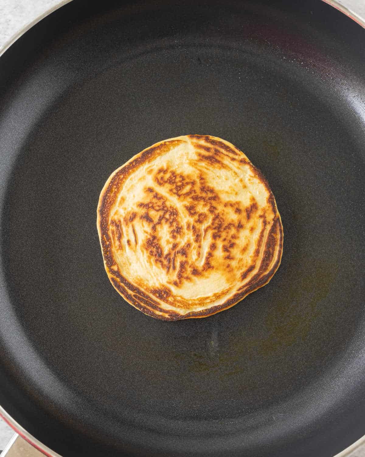 Black skillet with cornmeal pancake.