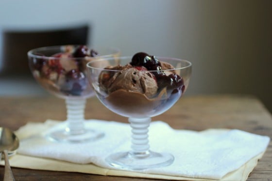 Two stem glasses with chocolate ice cream on white linen on wooden table