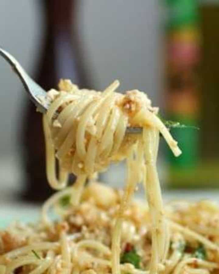 Fork holding long pasta with cauliflower pesto.