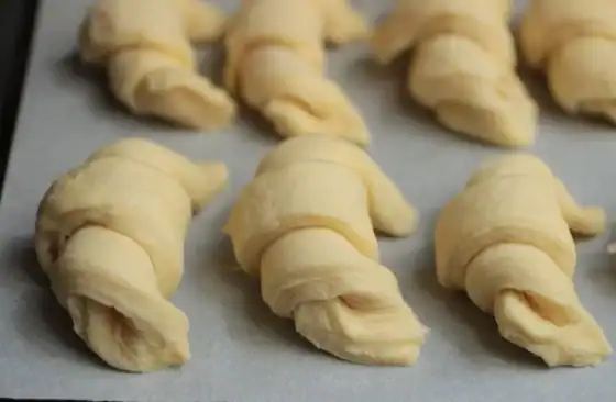Formed croissants on parchment before baking.