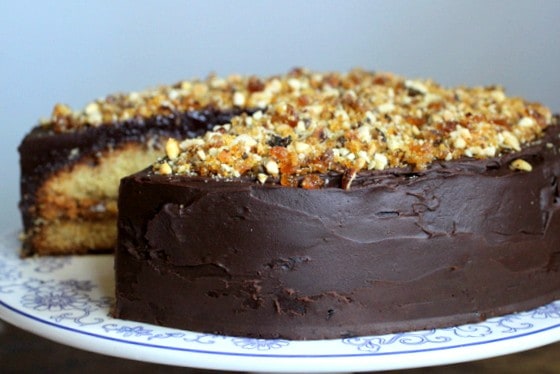 Chocolate covered cake on a cake stand.