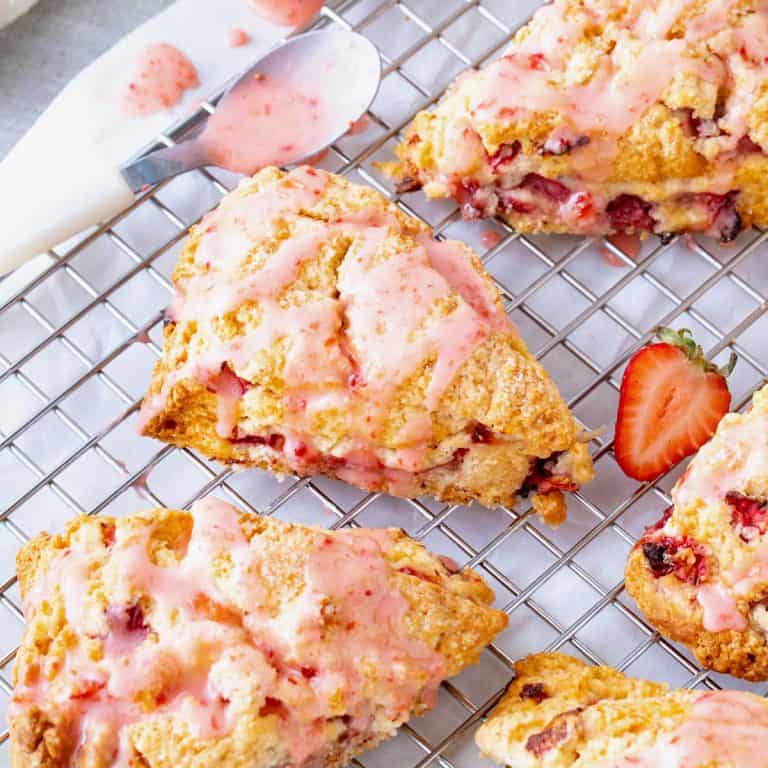 Strawberry scones on wire rack, white background