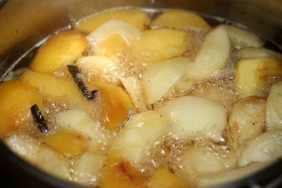Peach pieces boiling in large saucepan
