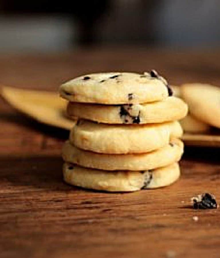 Stack of olive cookies on a wooden tables