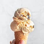 Light gray background with chocolate chip cookie ice cream in a cone.