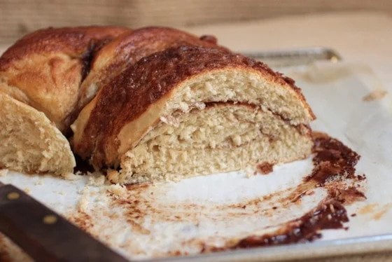 Cut cinnamon challah bread on parchment paper. 