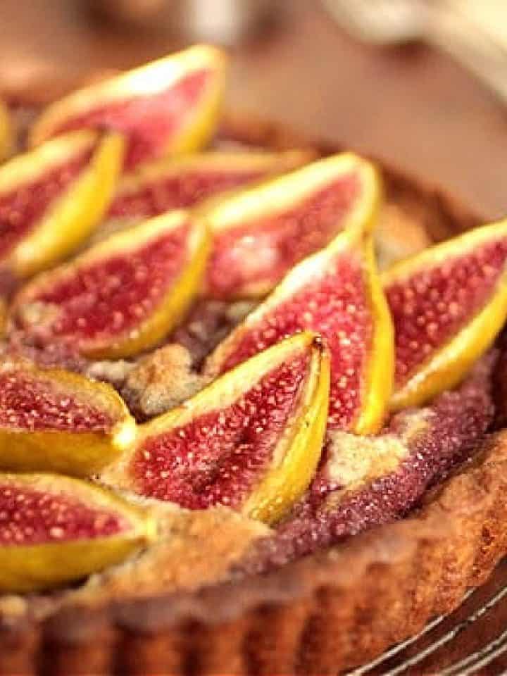 Partial view of fresh fig tart on wooden table
