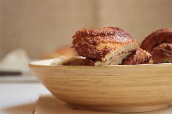 Cinnamon sugar challah pieces in a beige oval container. 