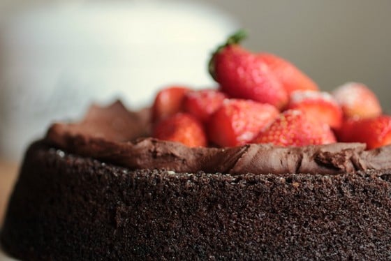 Close up of strawberry mound on top of a chocolate cake