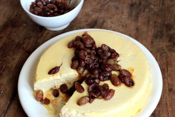 Cheesecake on white plate on a wooden table.