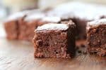 Close-up image of square of hazelnut brownie on wooden table