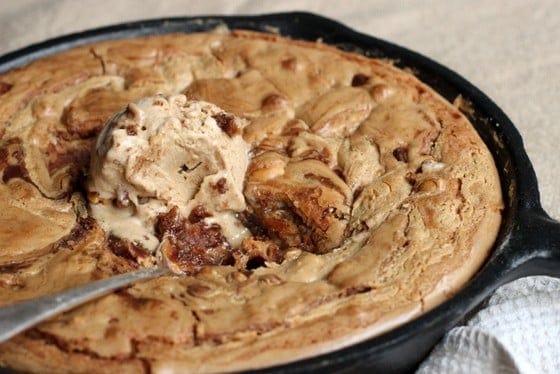 Cast iron skillet with peanut butter blondies with ice cream.