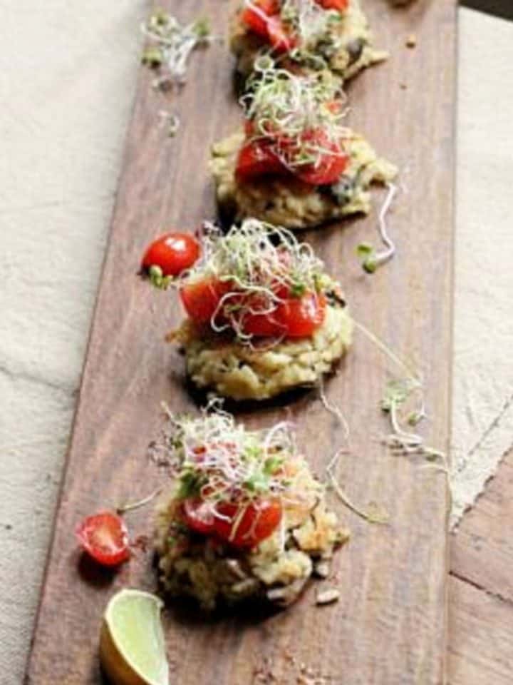 Row of risotto cakes on long wooden board