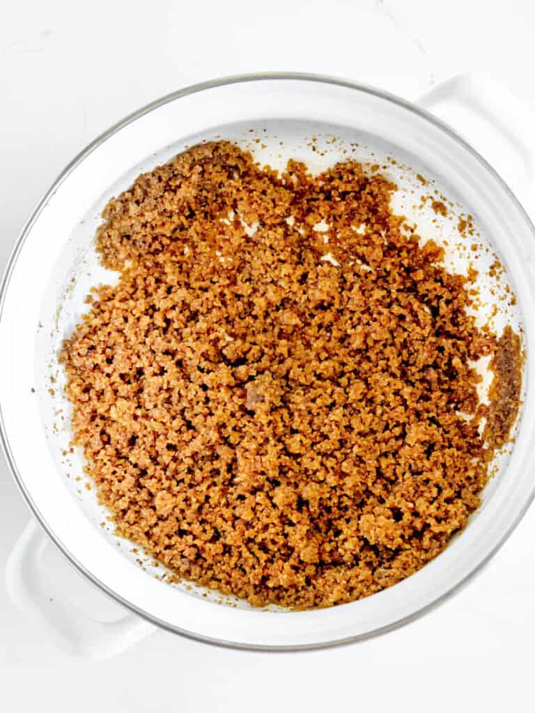 Brown butter breadcrumbs in a white saucepan. White background.