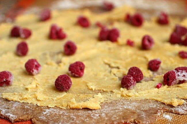 Graham cracker dough rolled with almond paste and raspberries on top. 