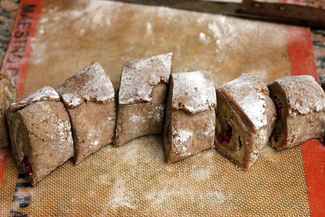 Cut rounds of cinnamon roll dough on a silpat surface. 