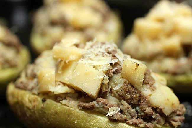 Meat and cheese filled potatoes ready for the oven