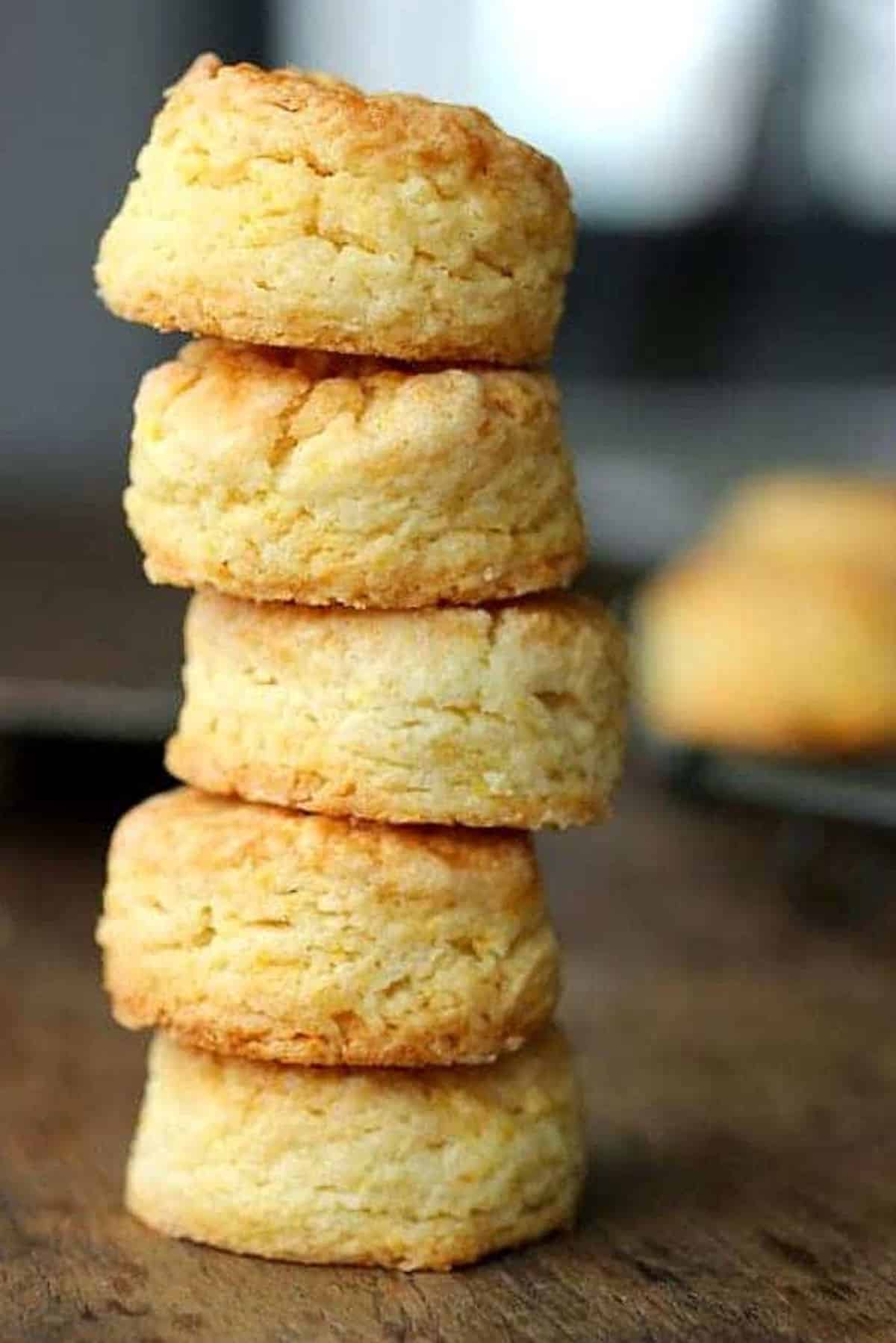 Wooden surface with stack of baked scones.