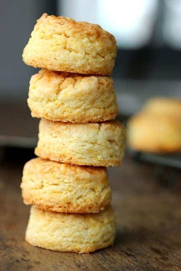Stack of five mini scones on wooden table.