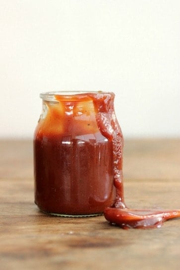 jar of smeared red Barbecue Sauce on wooden table