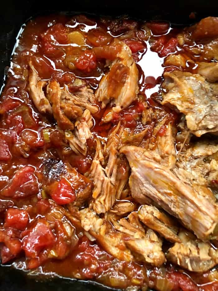 Shredded pieces of braised pork with chunky tomato sauce