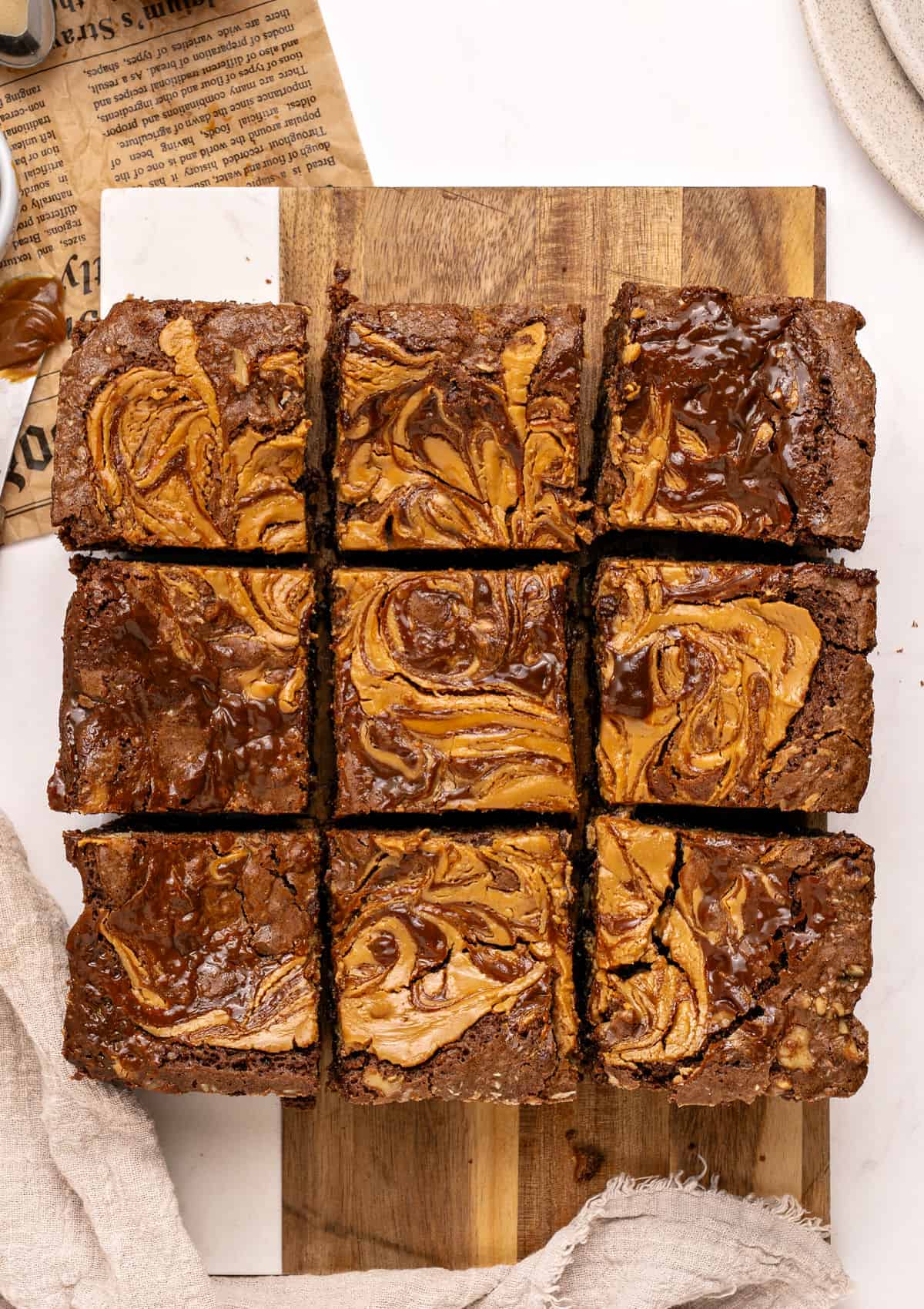Nine squares of kitchen sink brownies on a wooden board. Top view.