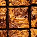Flat lay of loaded swirled brownie squares.