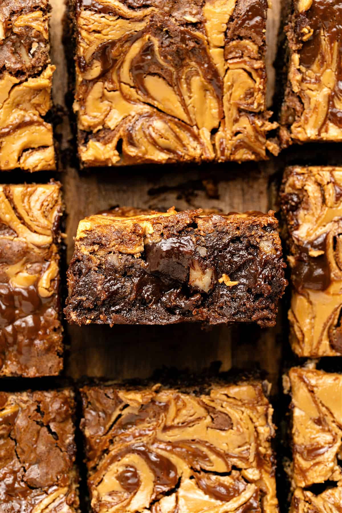 Killer Brownies Squares of loaded brownies on a wooden surface. Close up.