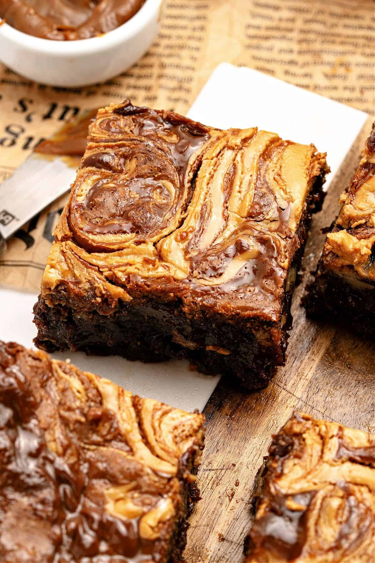 gooey killer brownies Newspaper sheet and white parchment with swirled brownie squares.
