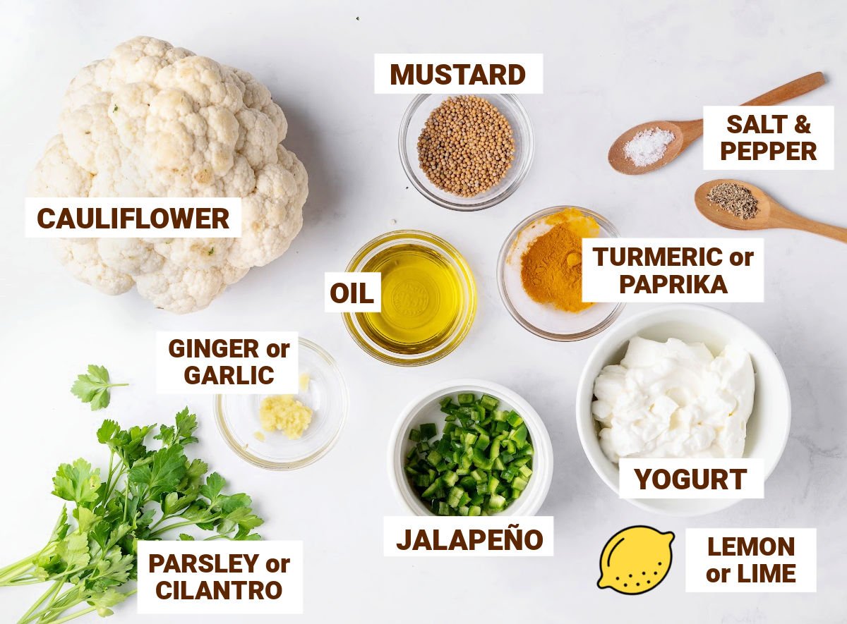 Bowls with ingredients for spicy cauliflower bites including herbs, oil, lemon and yogurt.