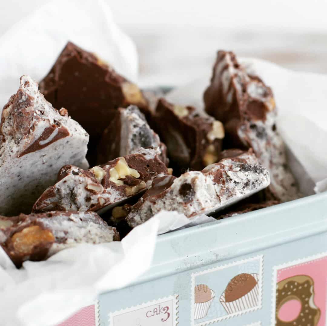 Double chocolate bark in pastel color box, silk paper, white table.