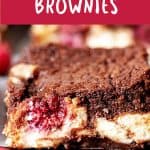 Close up of cut raspberry cheesecake brownie on a wooden surface. Purple and white text overlay.