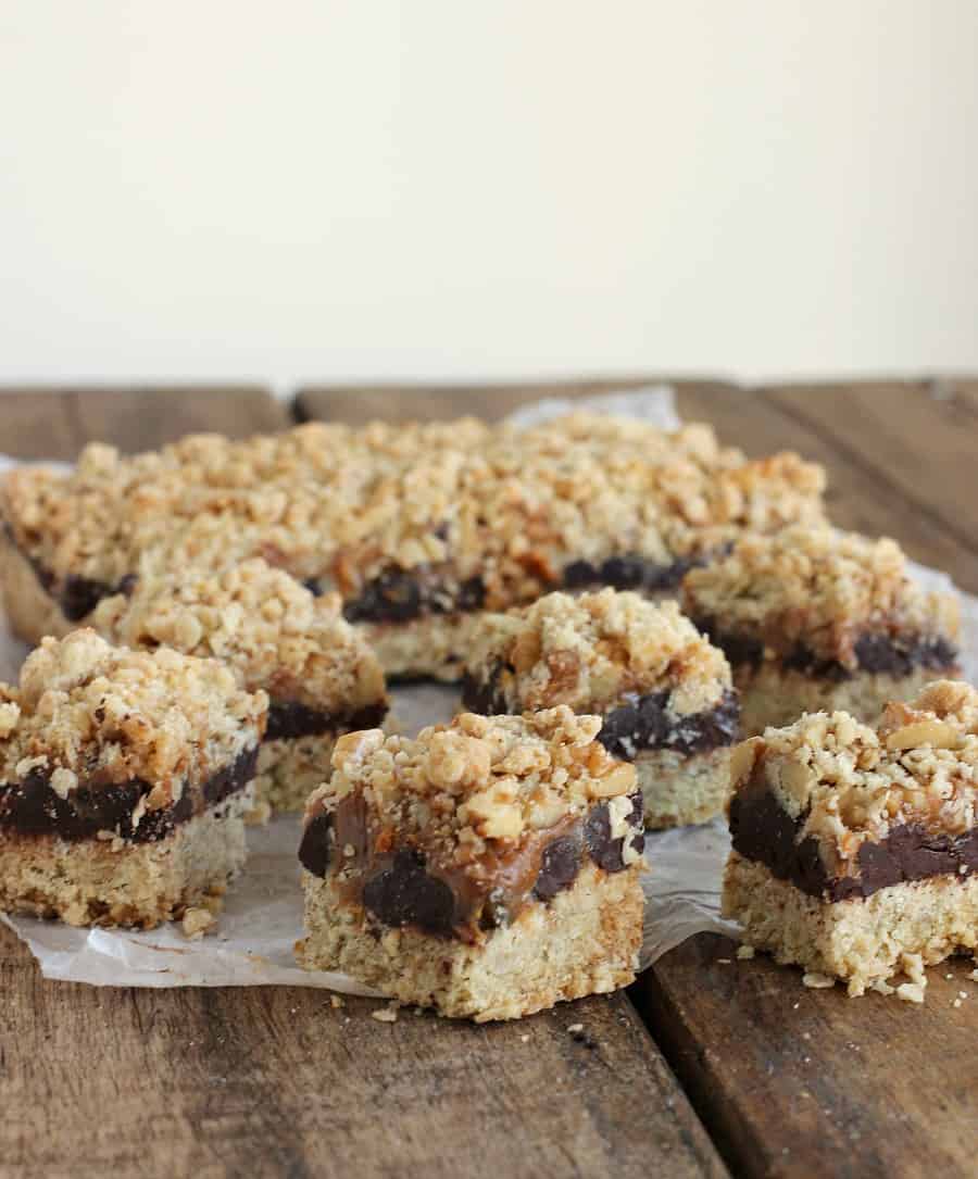 Chocolate oatmeal bars on parchment paper, wooden table